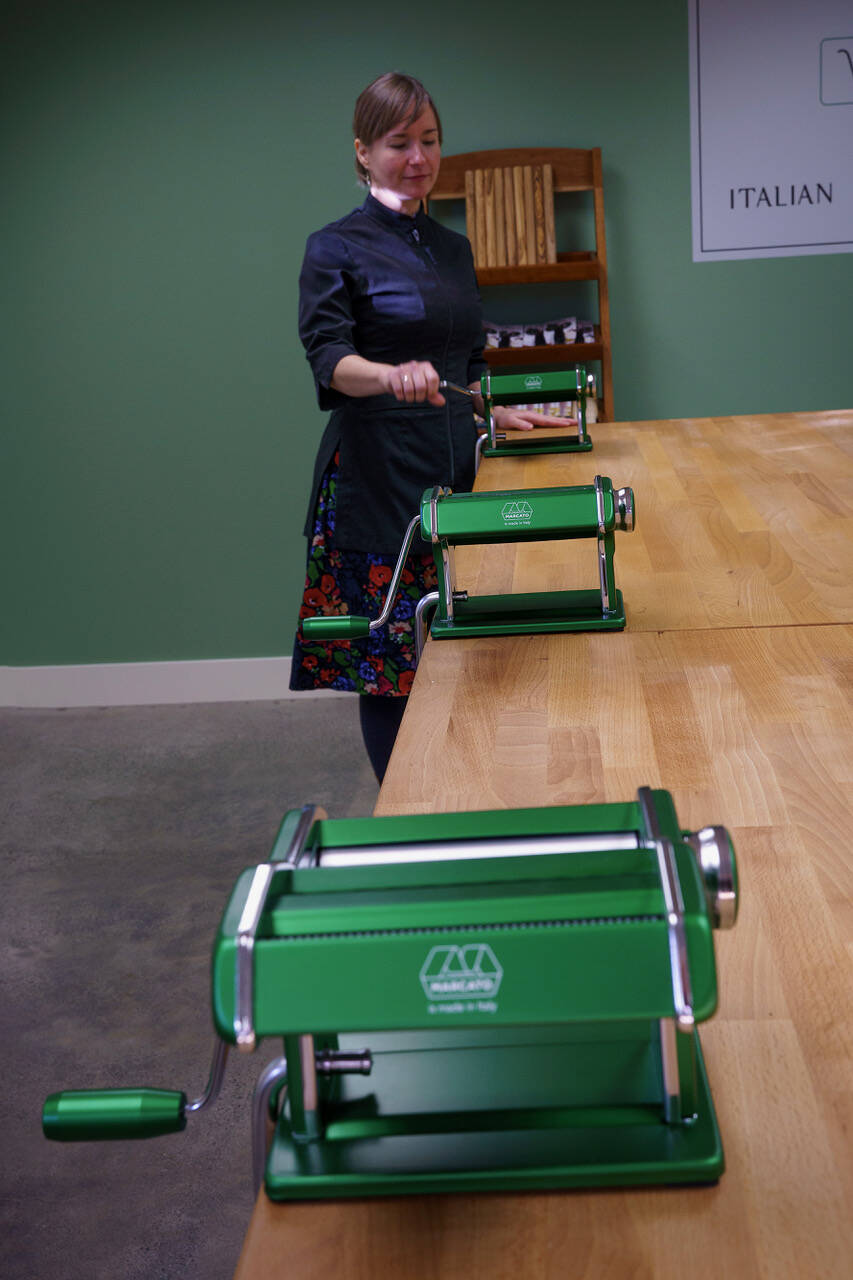 Echo stands by the pasta rollers in her pasta classroom. (Photo by David Welton)